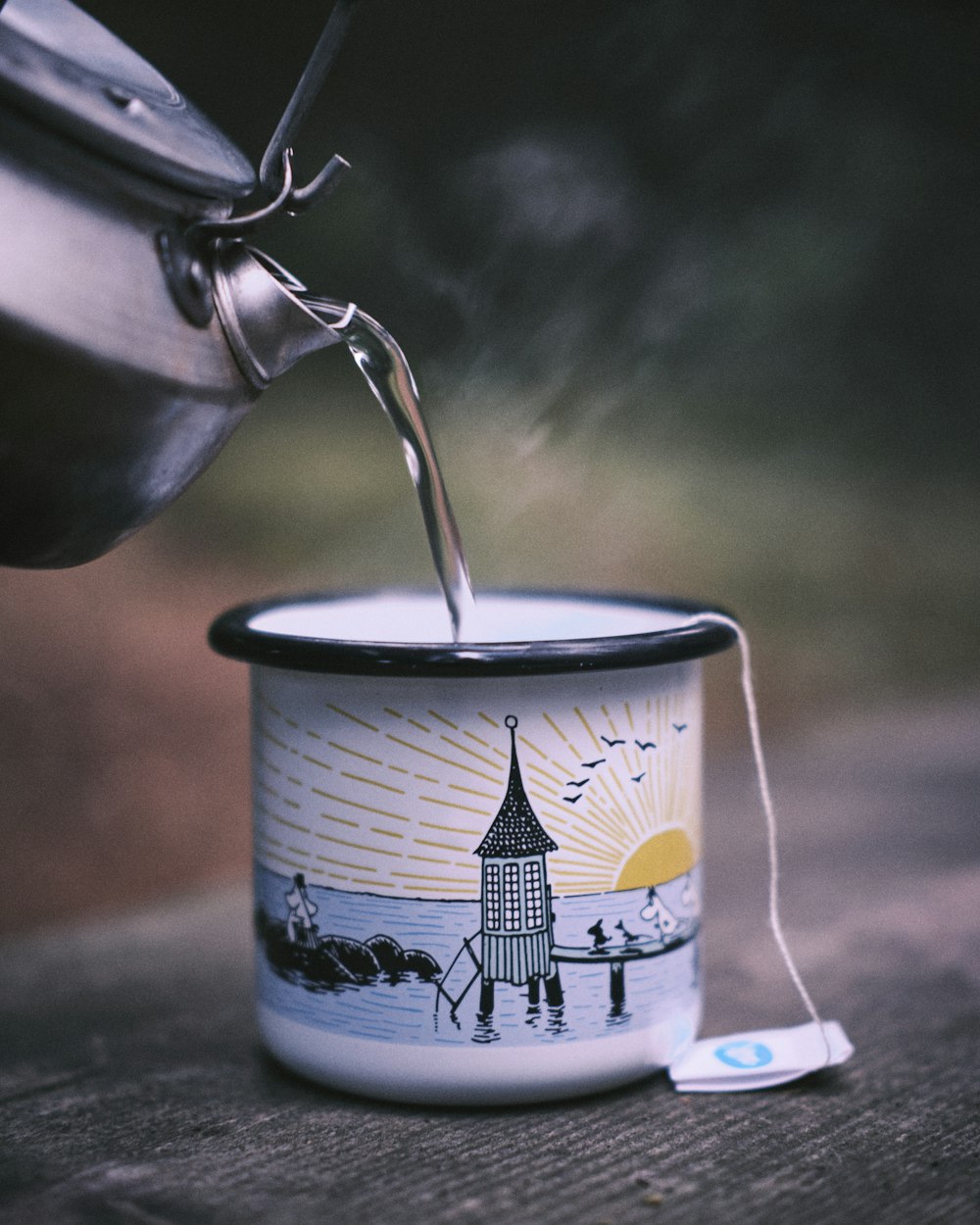 white and blue floral ceramic mug with silver spoon