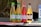 Four bottles of Wild Leaf Kombucha are lined up on a dark surface. Each bottle has a different flavor and label color: lime cucumber mint, apple ginger, raspberry lavender hibiscus, and vanilla chai. The background appears to be a natural, outdoor setting.