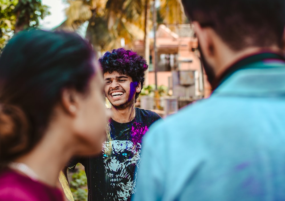 man in blue shirt beside woman in black and white floral shirt