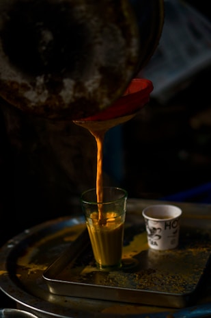 clear drinking glass with yellow liquid inside