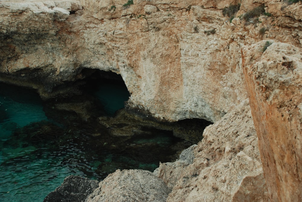 brown rock formation on blue sea during daytime