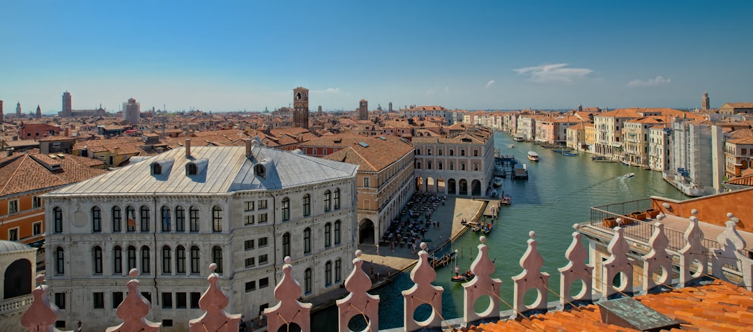 people in the river near buildings during daytime