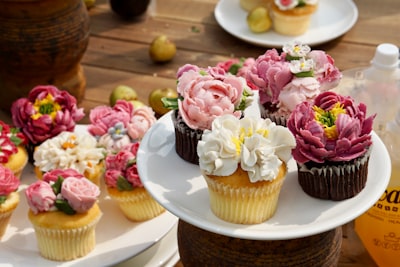 pink and white flower bouquet on white ceramic plate dessert teams background