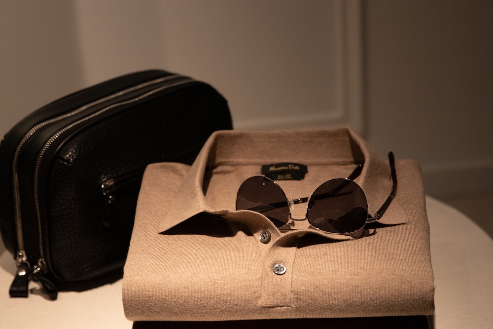 black framed sunglasses on brown box