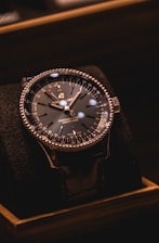 silver and black round analog watch