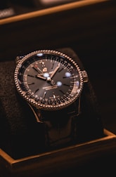 silver and black round analog watch