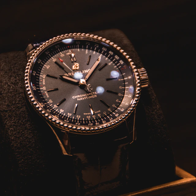 A silver and black round analog wristwatch
