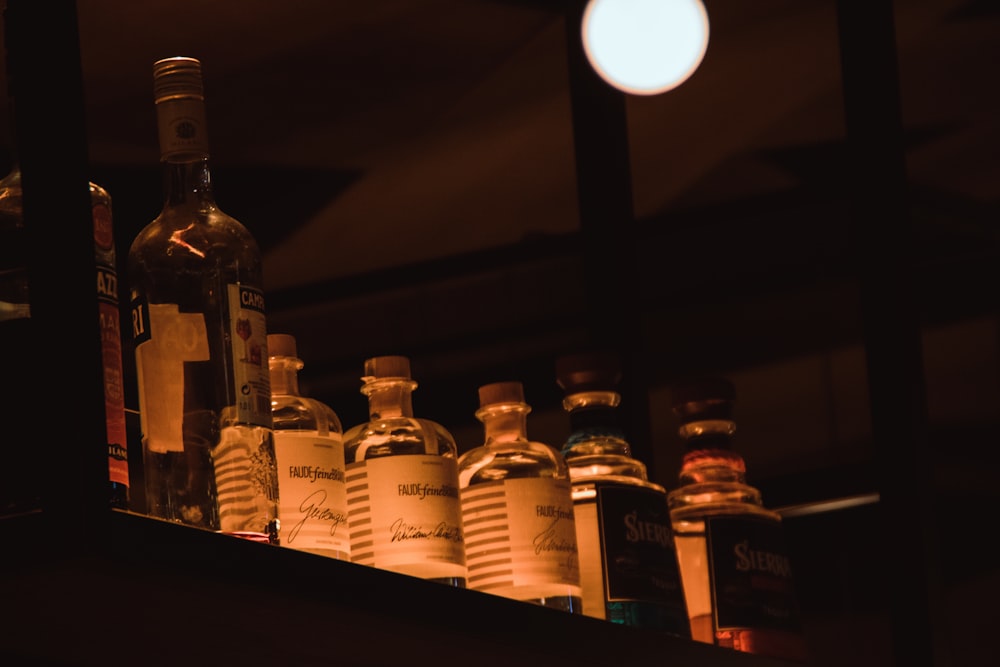 clear glass bottles on brown wooden table