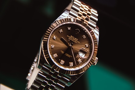 silver and gold round analog watch at 10 10