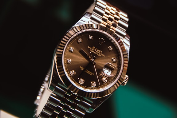silver and gold round analog watch at 10 10