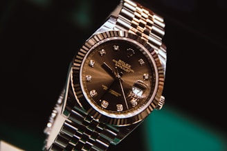 silver and gold round analog watch at 10 10