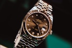 silver and gold round analog watch at 10 10