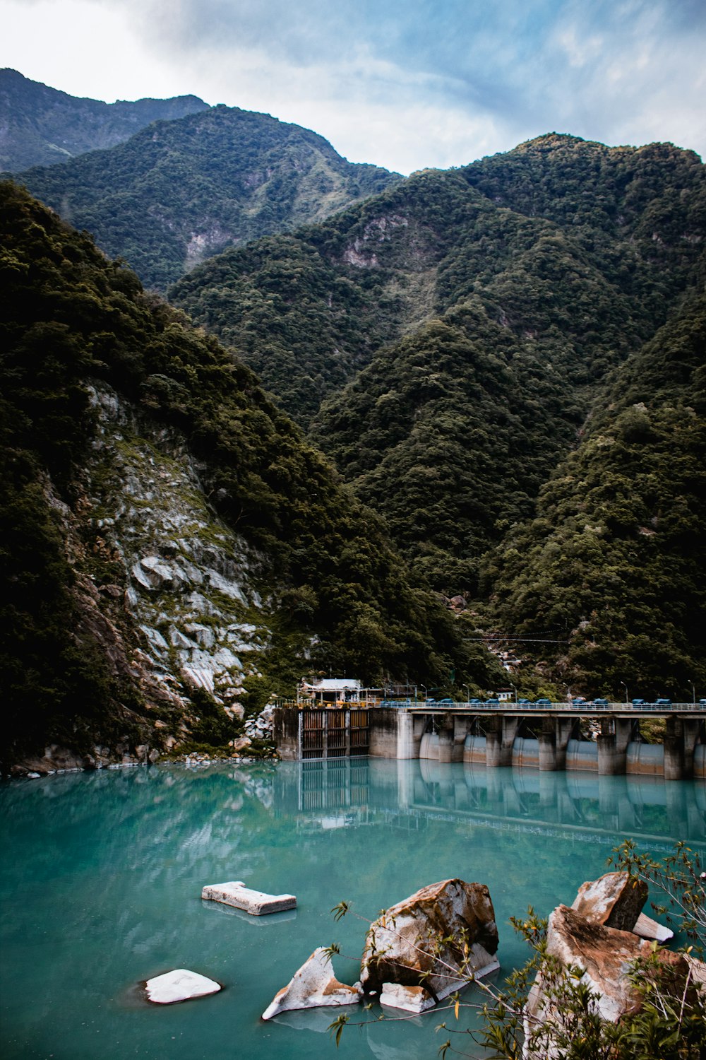 green river between green mountains during daytime