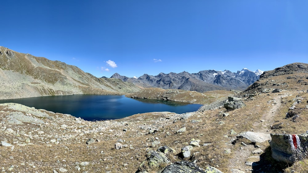 lake in the middle of mountains during daytime