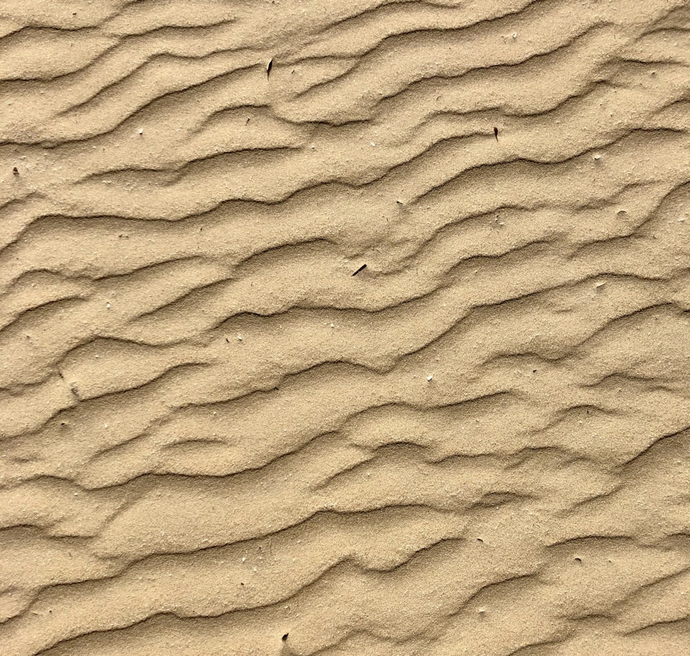 brown sand with footprints during daytime