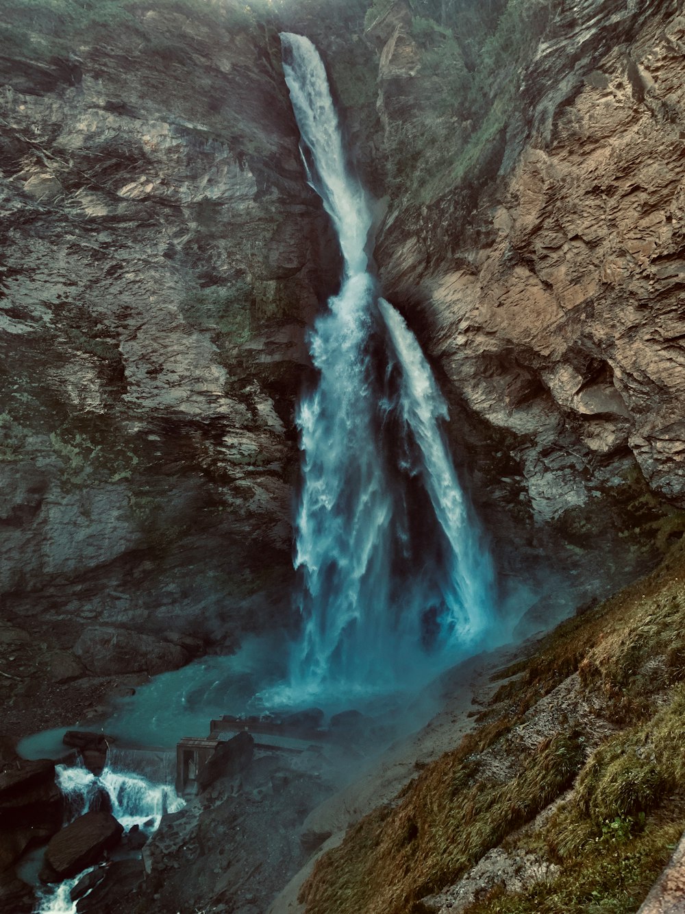 waterfalls on rocky mountain during daytime