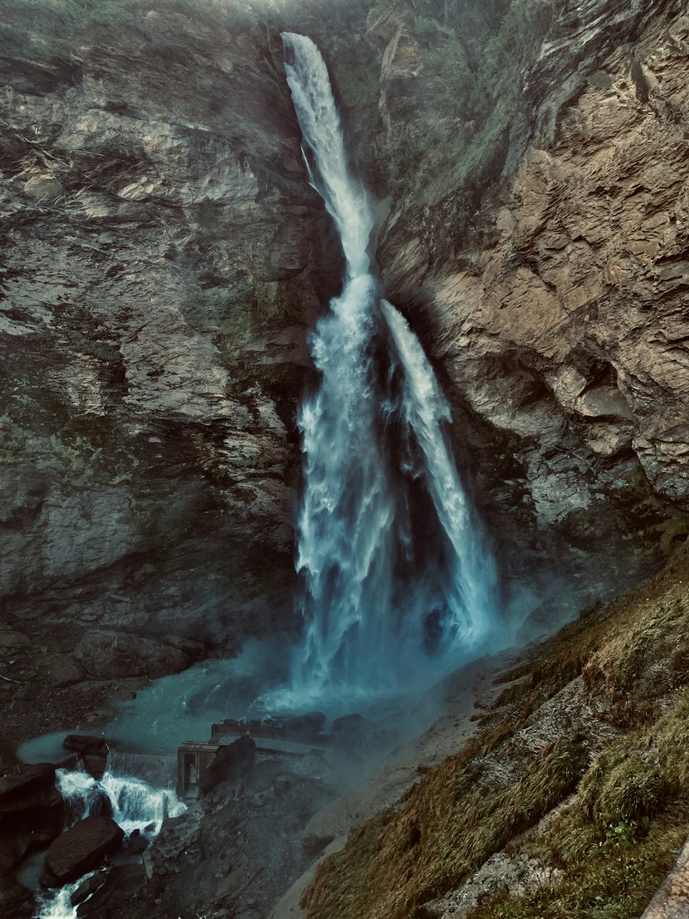 waterfalls on rocky mountain during daytime