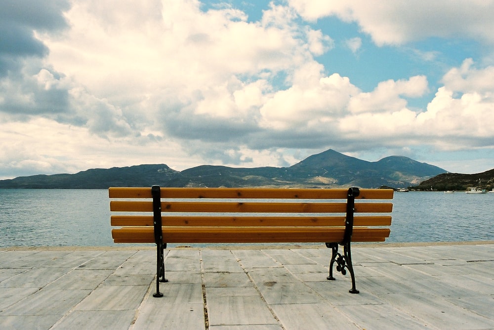 brown wooden bench on gray concrete floor