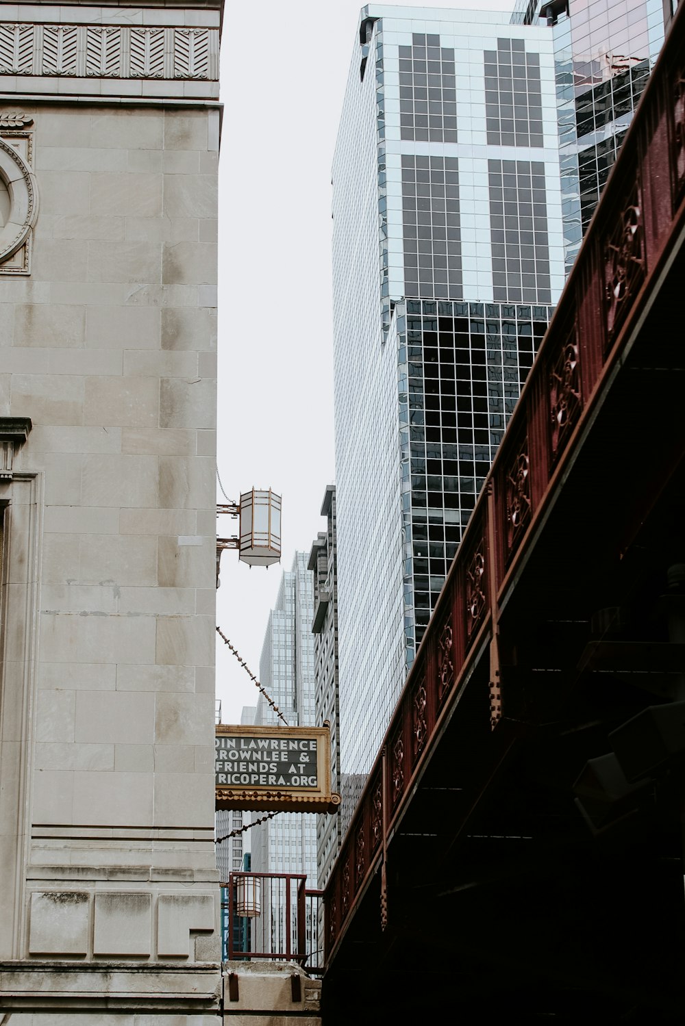 red and white bridge over the city during daytime