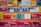 A variety of colorful maps and travel guides are displayed on wooden shelves. The maps are arranged in an orderly manner, with different sizes and titles visible, including Ordnance Survey maps and others for locations like France, Norwich, and Bournemouth.
