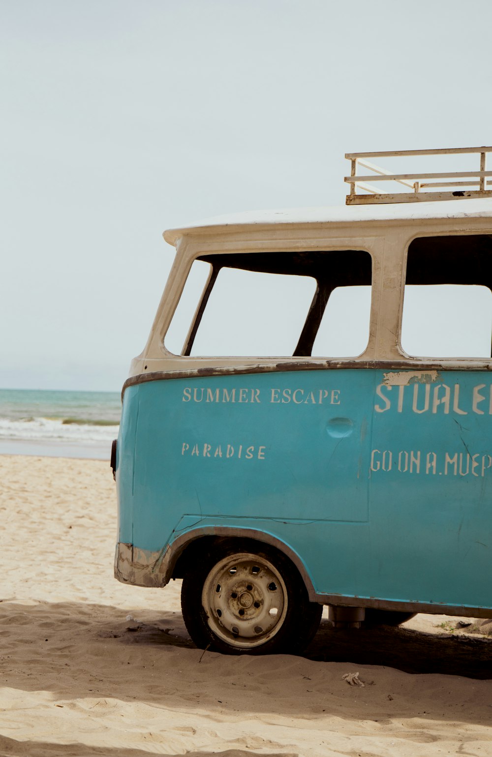 blue and white volkswagen t-2 on beach shore during daytime