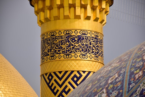 Close-up of intricate gold leaf details on a mosque pulpit.
