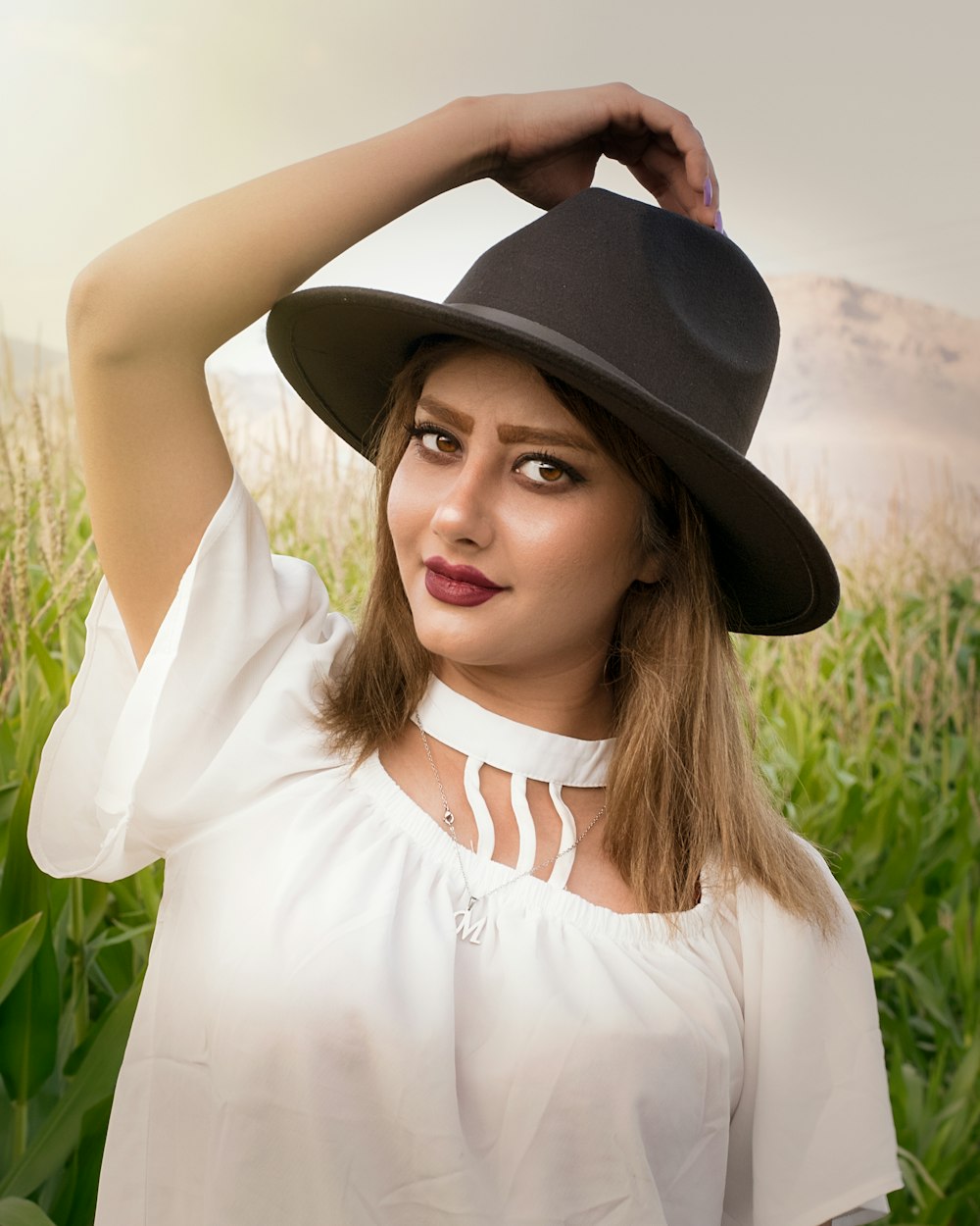 woman in white shirt wearing black fedora hat