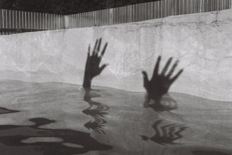 person in water in grayscale photography