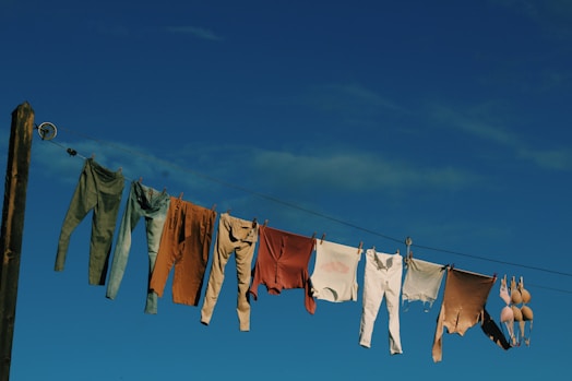 white and blue textiles on wire during daytime
