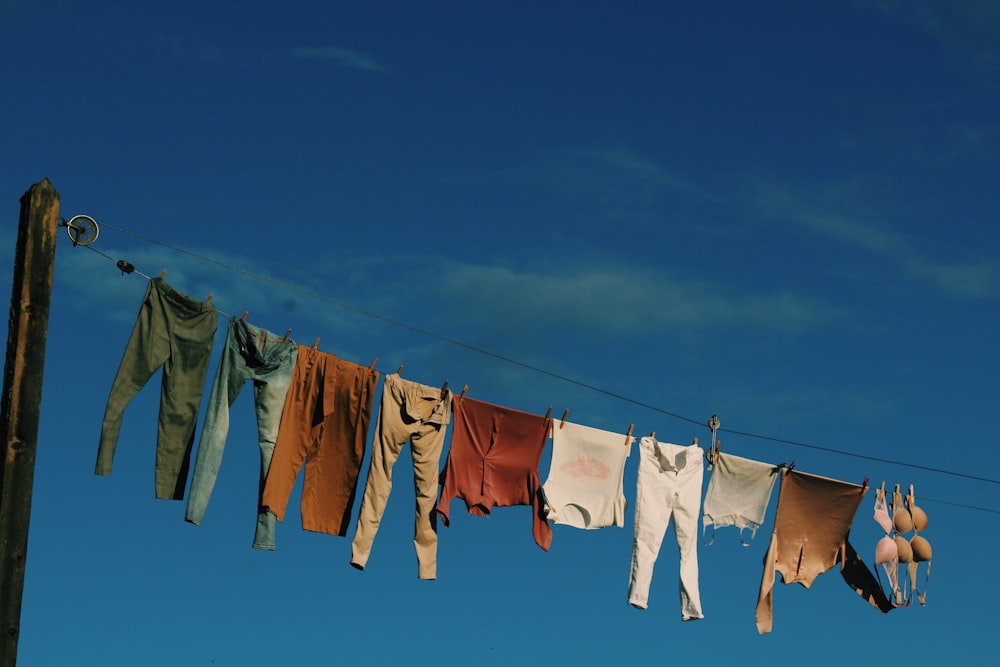 white and blue textiles on wire during daytime