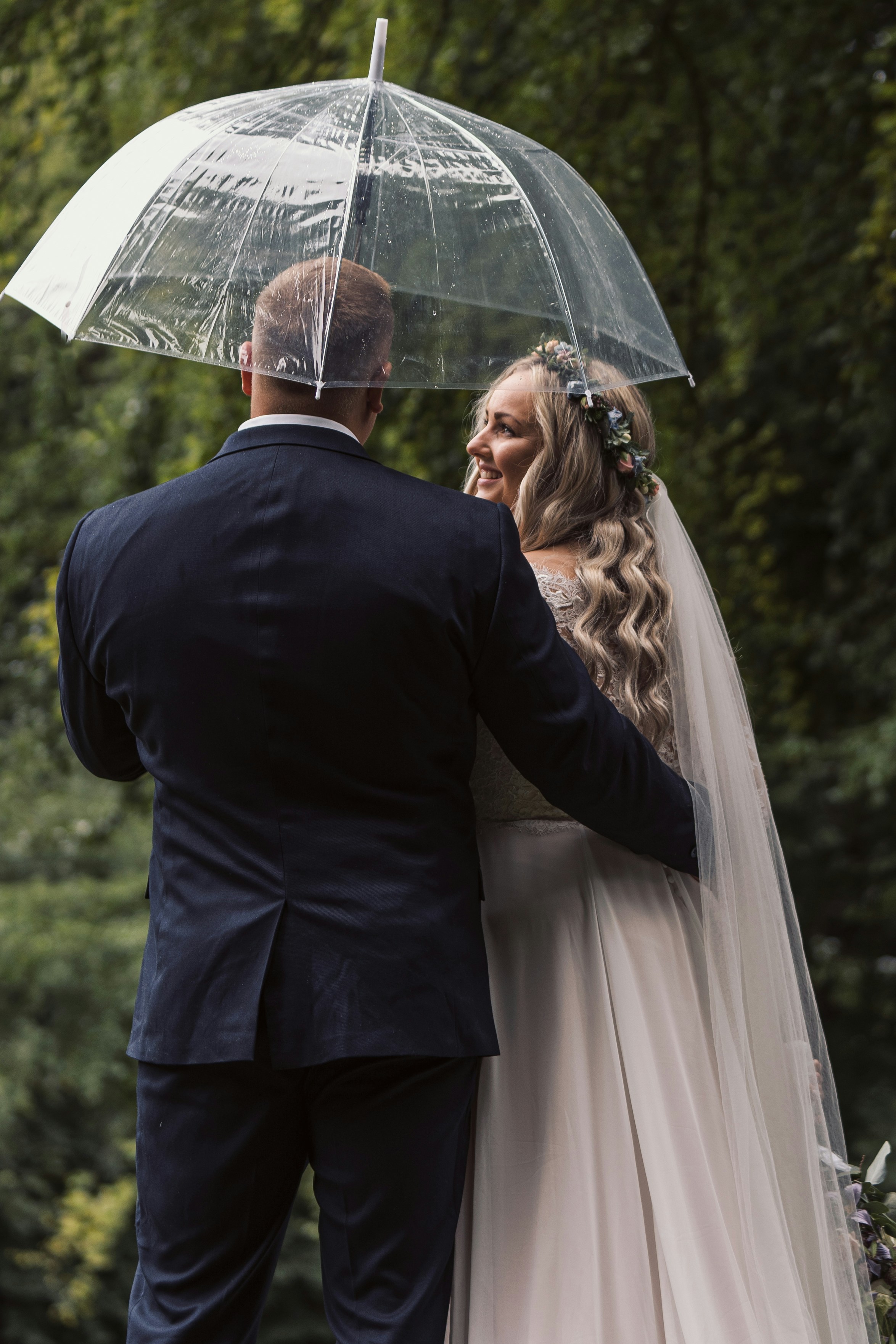 man and woman holding umbrella