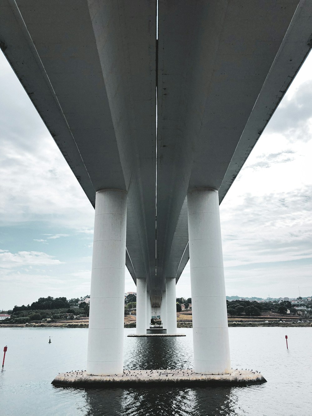white concrete bridge over body of water during daytime