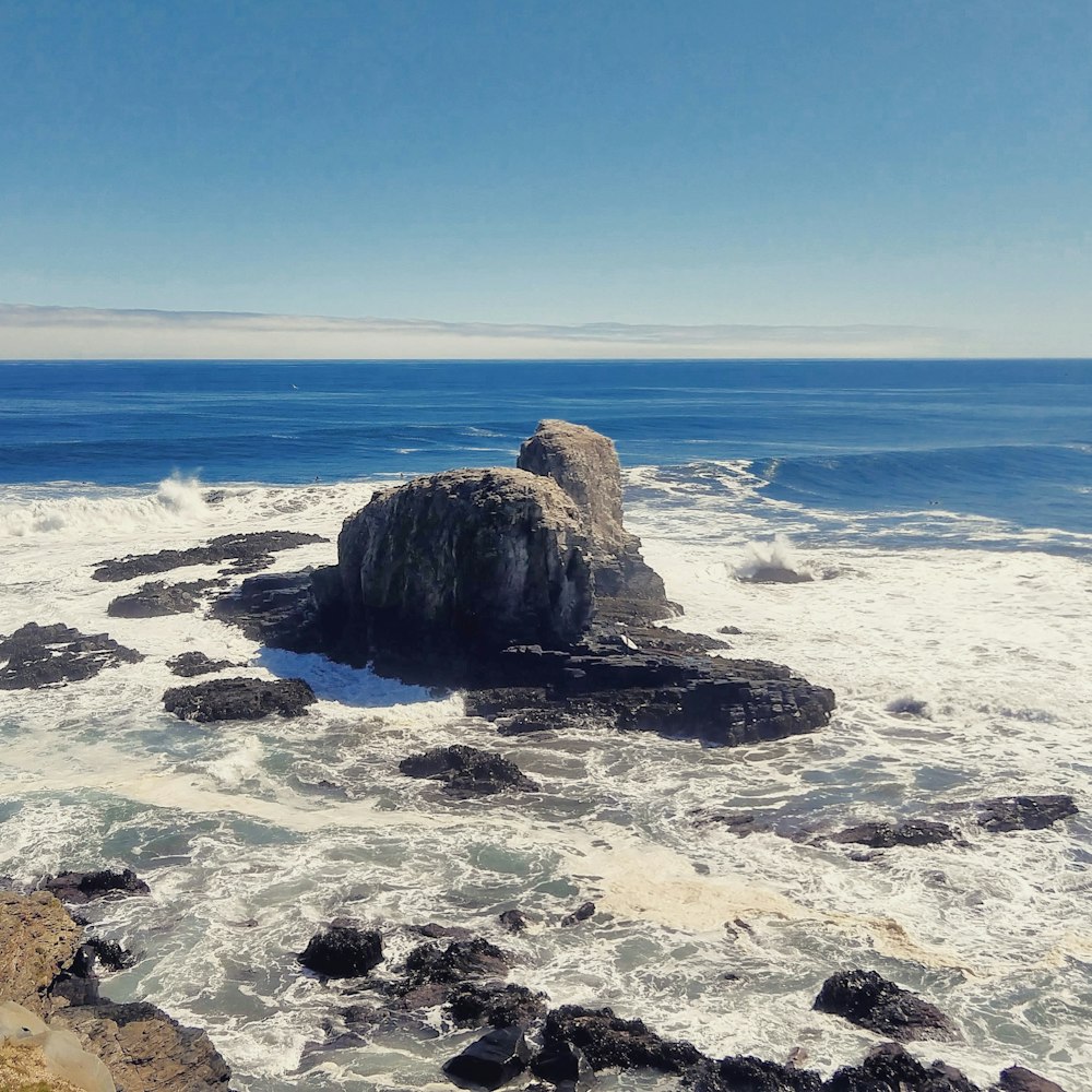 brown rock formation on sea shore during daytime