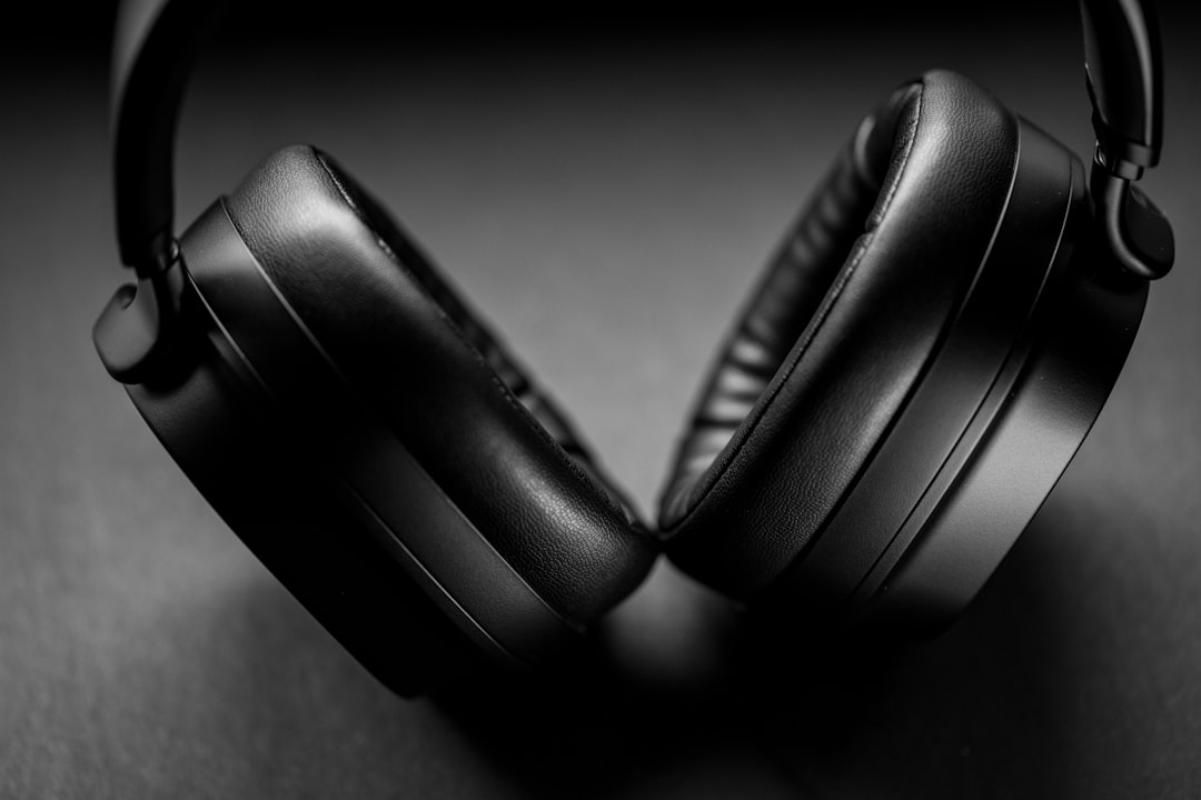 black headphones on gray textile