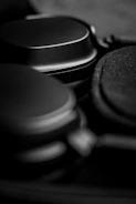 Close-up of a titanium alloy headphone shell being CNC machined with fine detail.