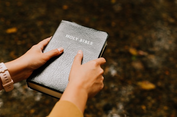 A person holding Bible