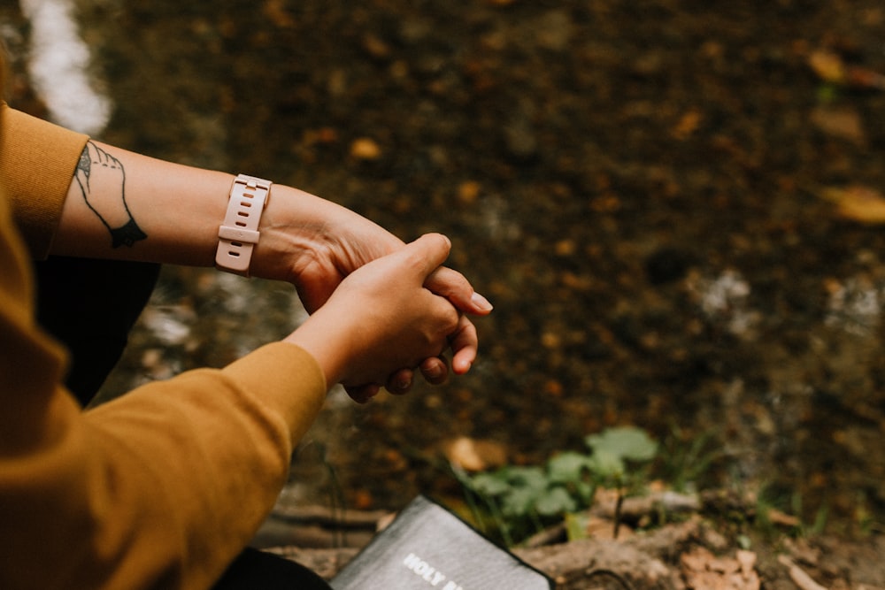 person wearing white band ring