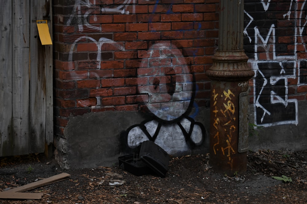 black charcoal grill beside brown brick wall