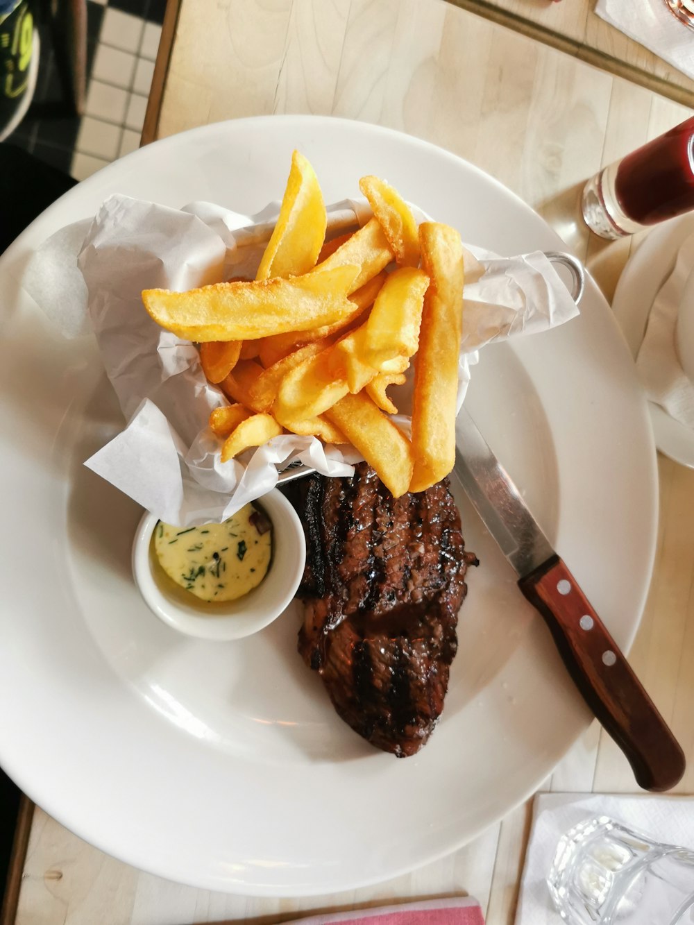 burger and fries on white ceramic plate