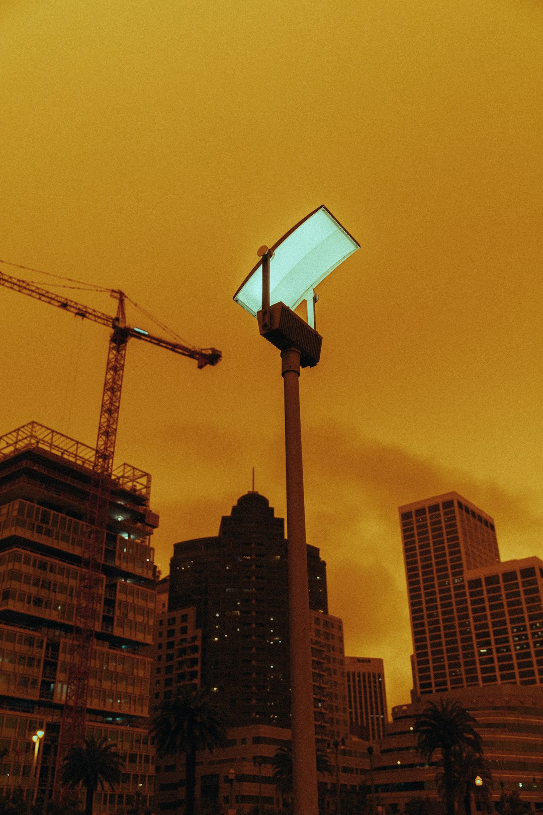 black crane near high rise building during daytime