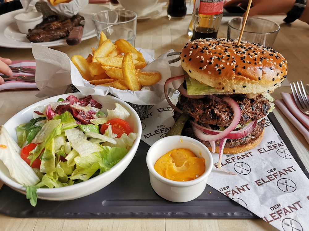 burger and fries on white ceramic plate