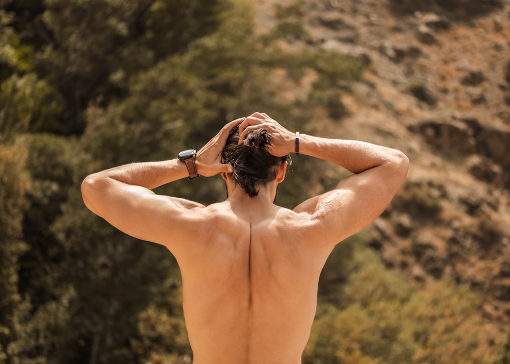 topless woman with black hair covering her face