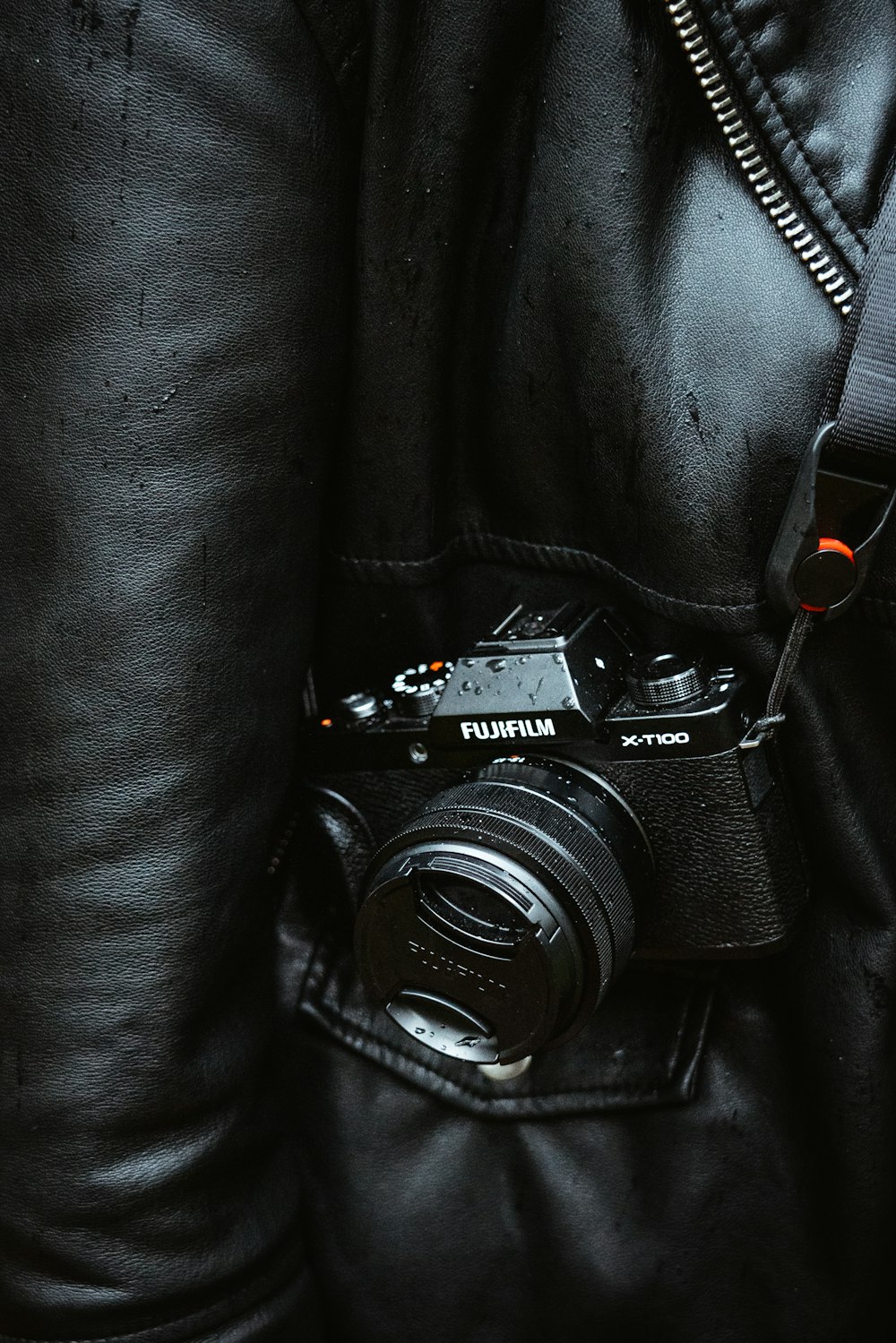black nikon dslr camera on black leather textile
