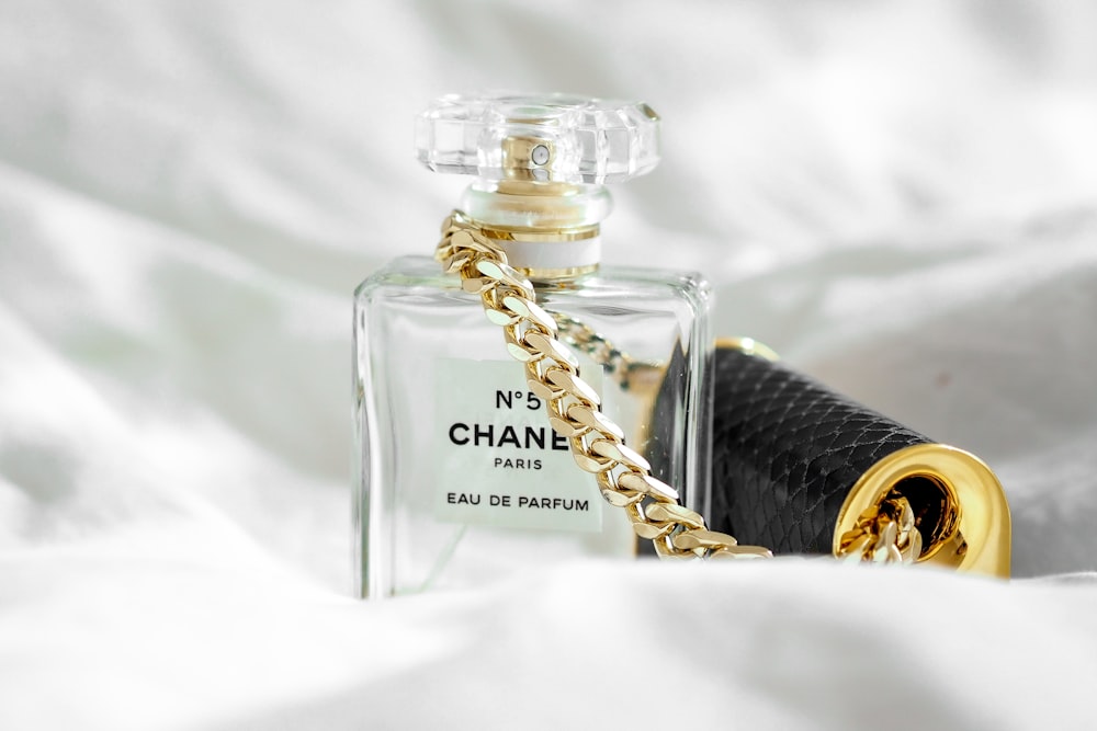 a bottle of chanel no 5 on a bed