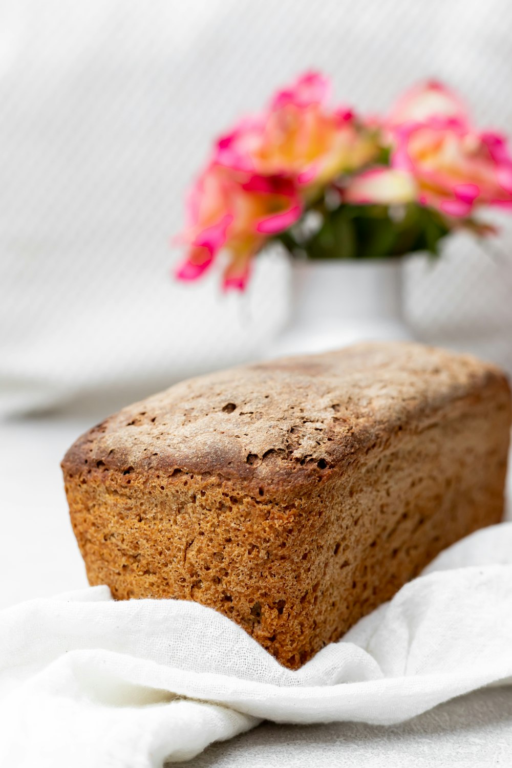 brown bread with pink and white flowers on white textile