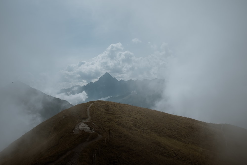 brown mountain under white clouds during daytime