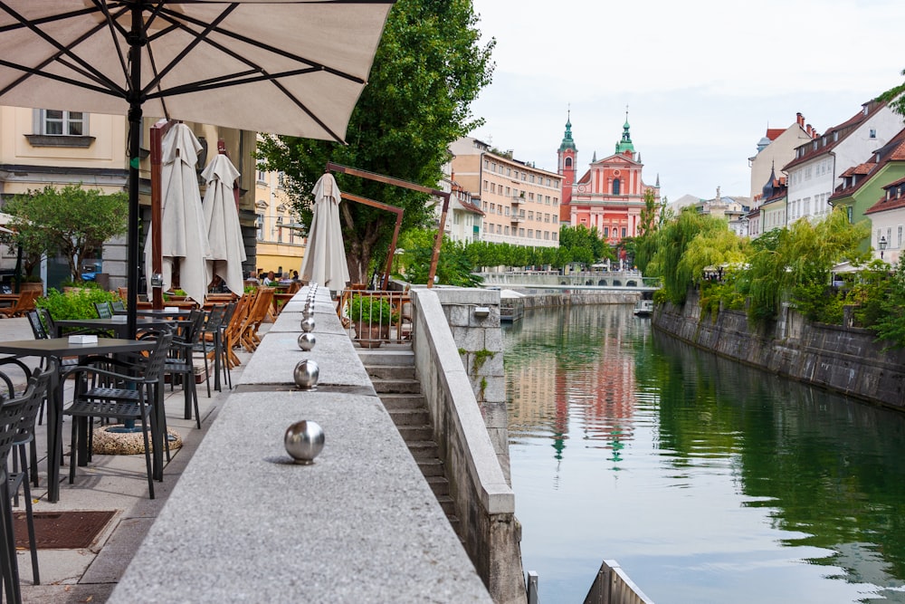 brown wooden chairs and tables near river during daytime