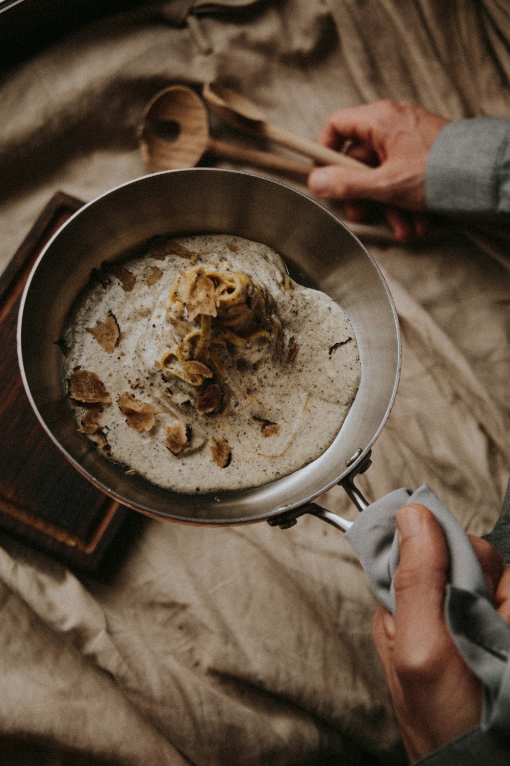 person holding stainless steel round tray with food