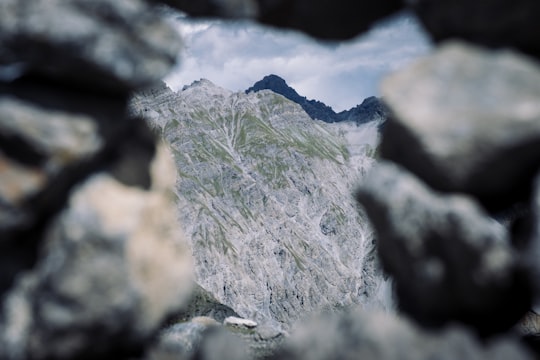 green and gray rocky mountain in Swiss National Park Switzerland