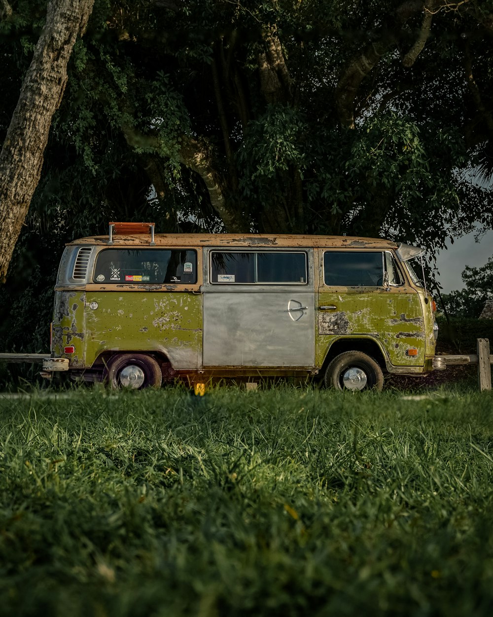 brown and white van parked on green grass field during daytime